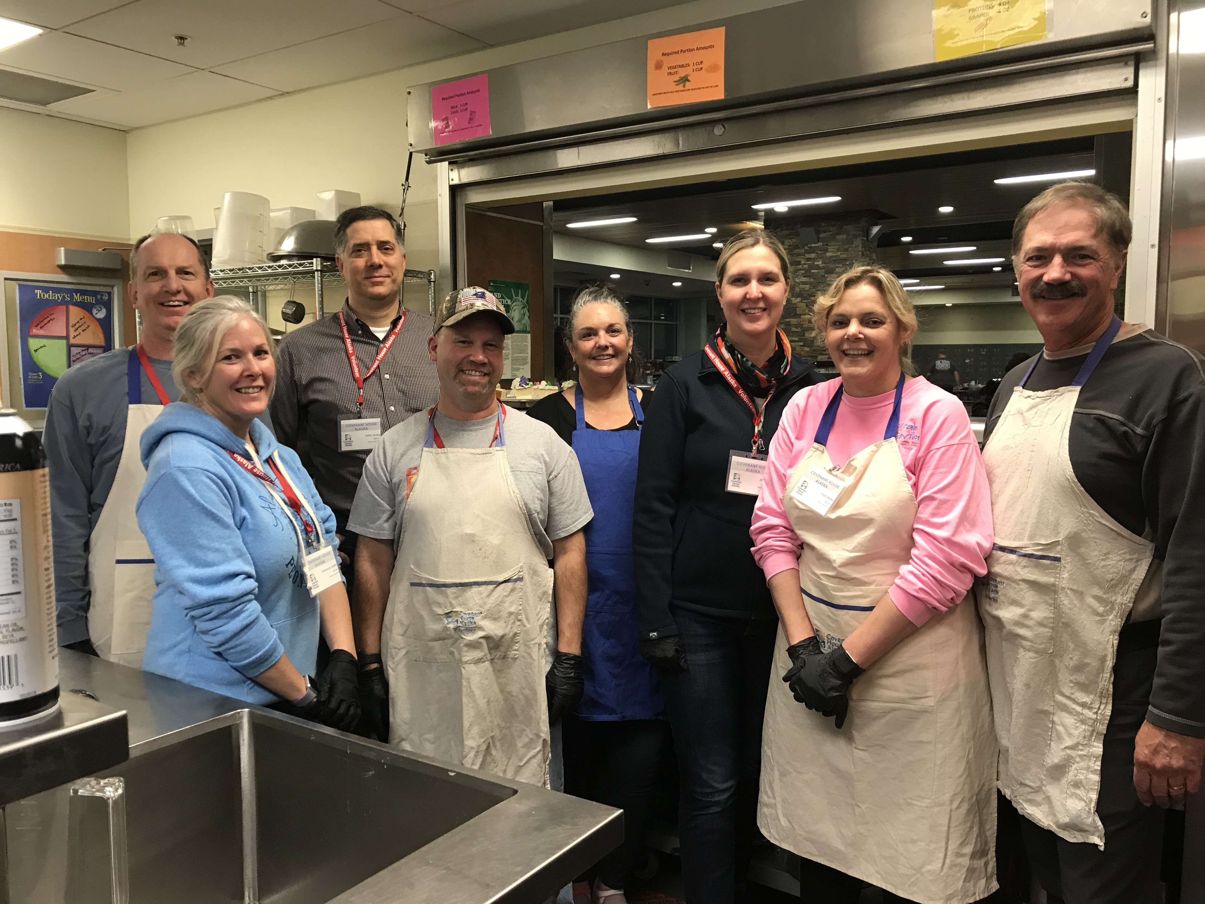 Volunteer group serving the monthly birthday dinner at the Youth Engagement Center