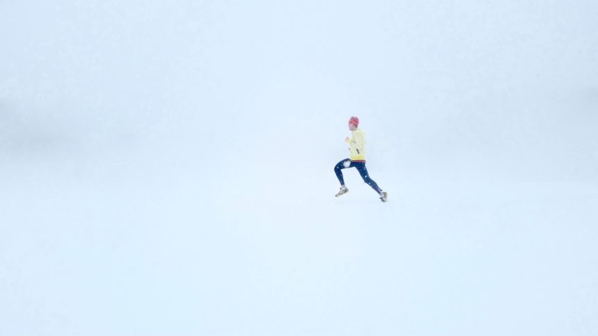 Man running through winter snow